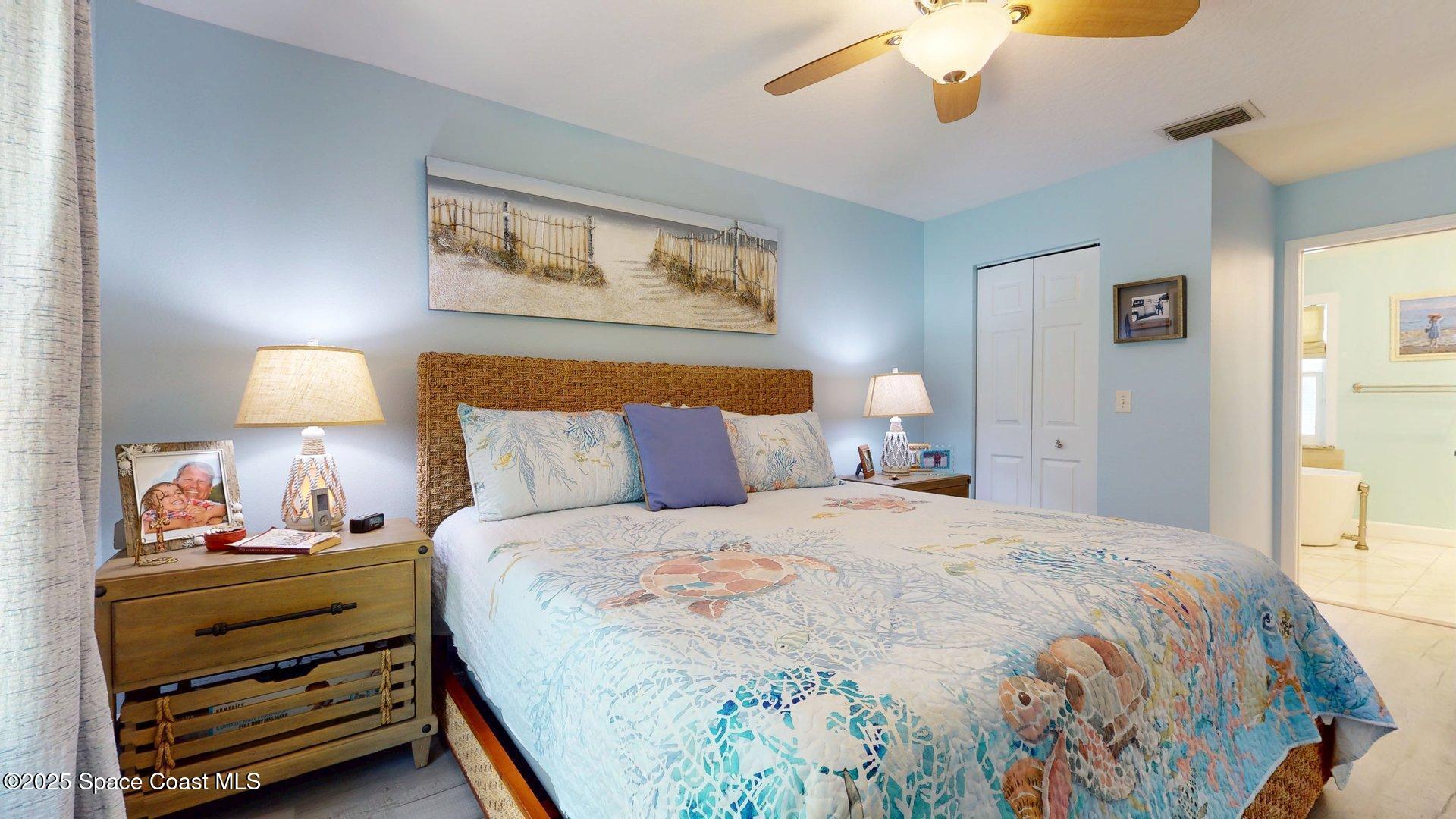 103 Matanzas Road Melbourne Beach, FL 32951 - Photo 17 of 37 a bedroom with a bed and a painting on the wall