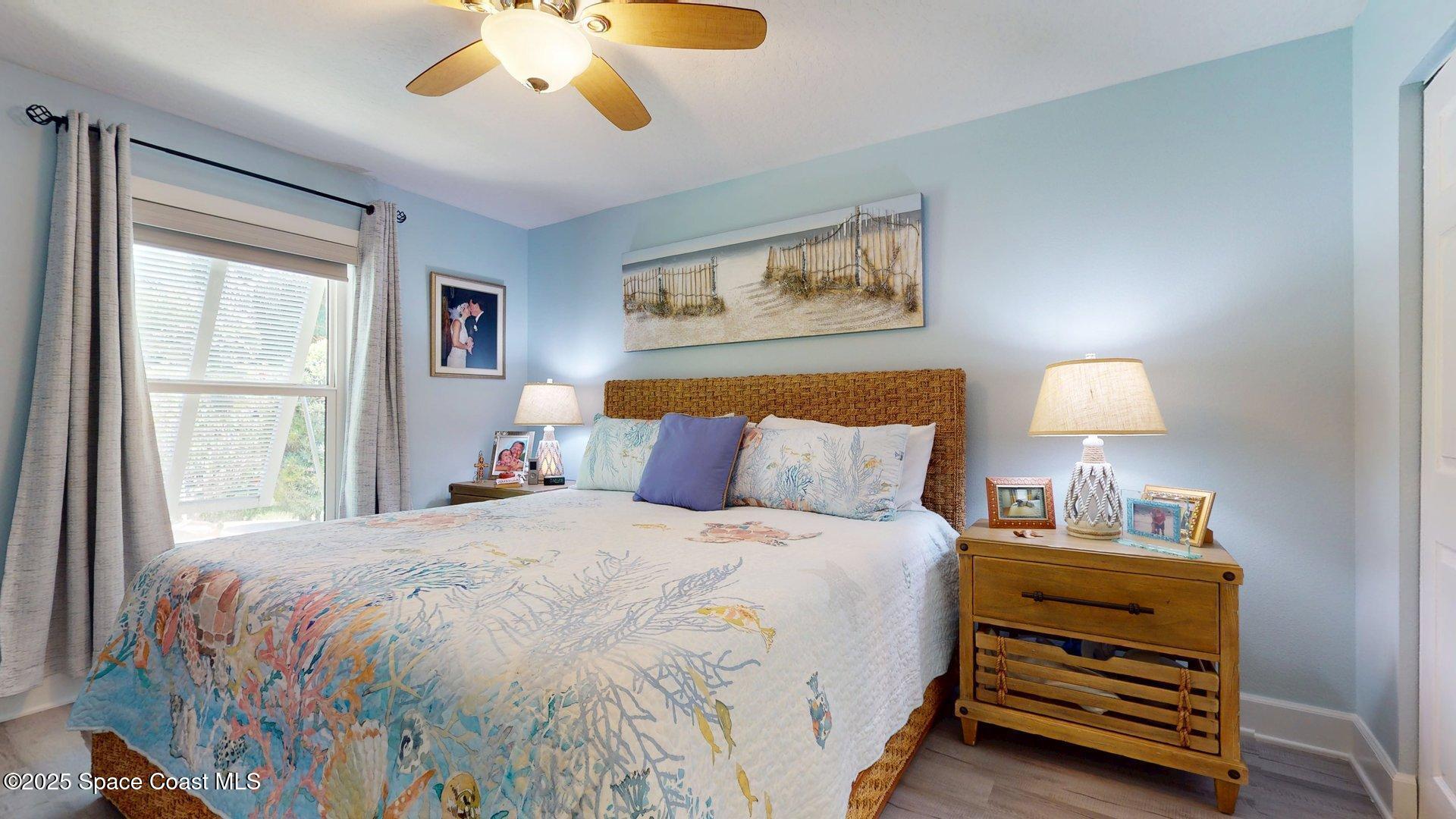 103 Matanzas Road Melbourne Beach, FL 32951 - Photo 18 of 37 a bedroom with a bed and a window