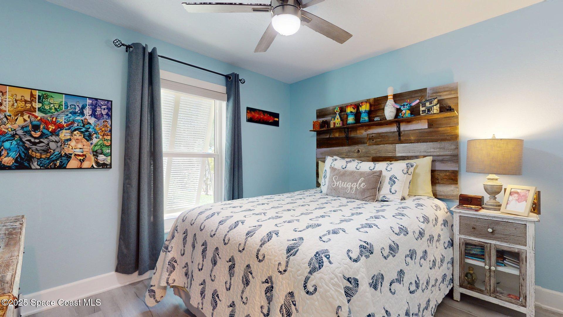 103 Matanzas Road Melbourne Beach, FL 32951 - Photo 22 of 37 a bedroom with a large bed and a chandelier