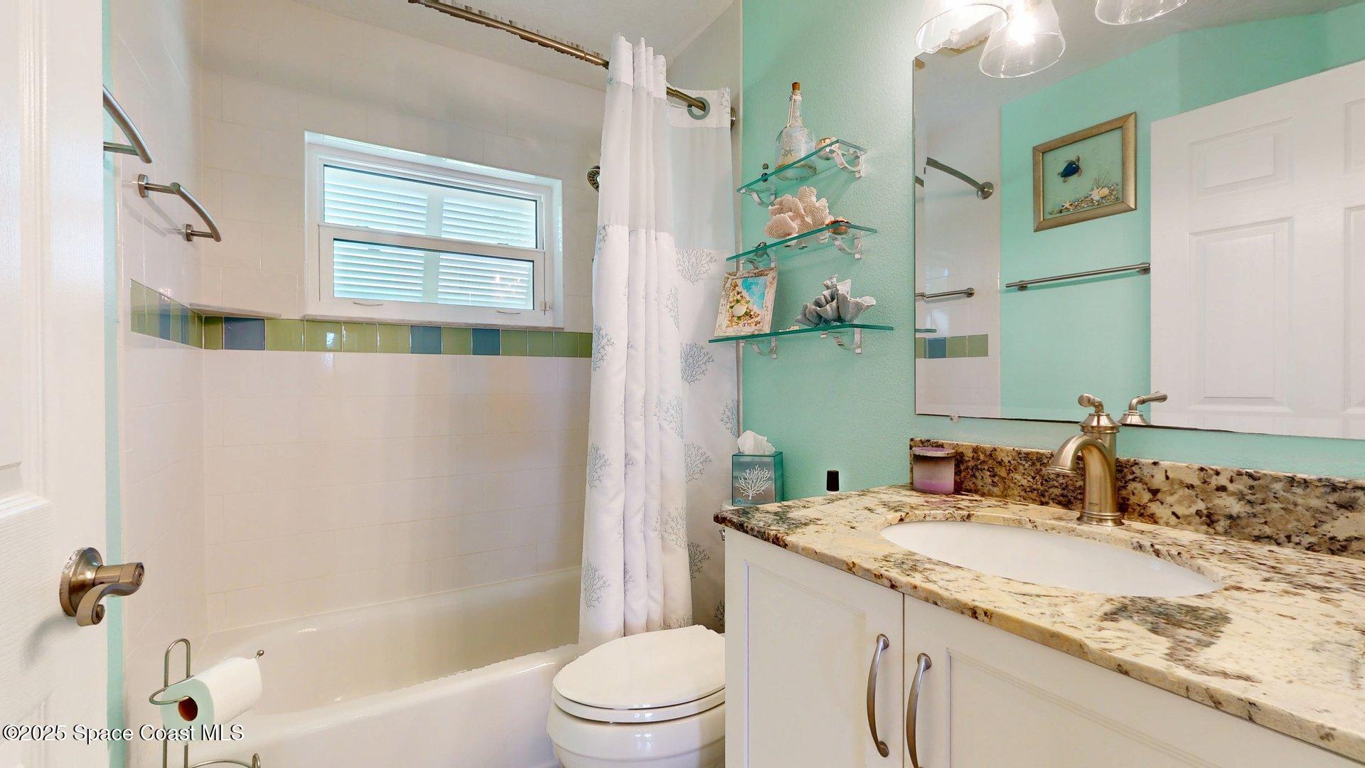 103 Matanzas Road Melbourne Beach, FL 32951 - Photo 24 of 37 a bathroom with a granite countertop sink and a mirror