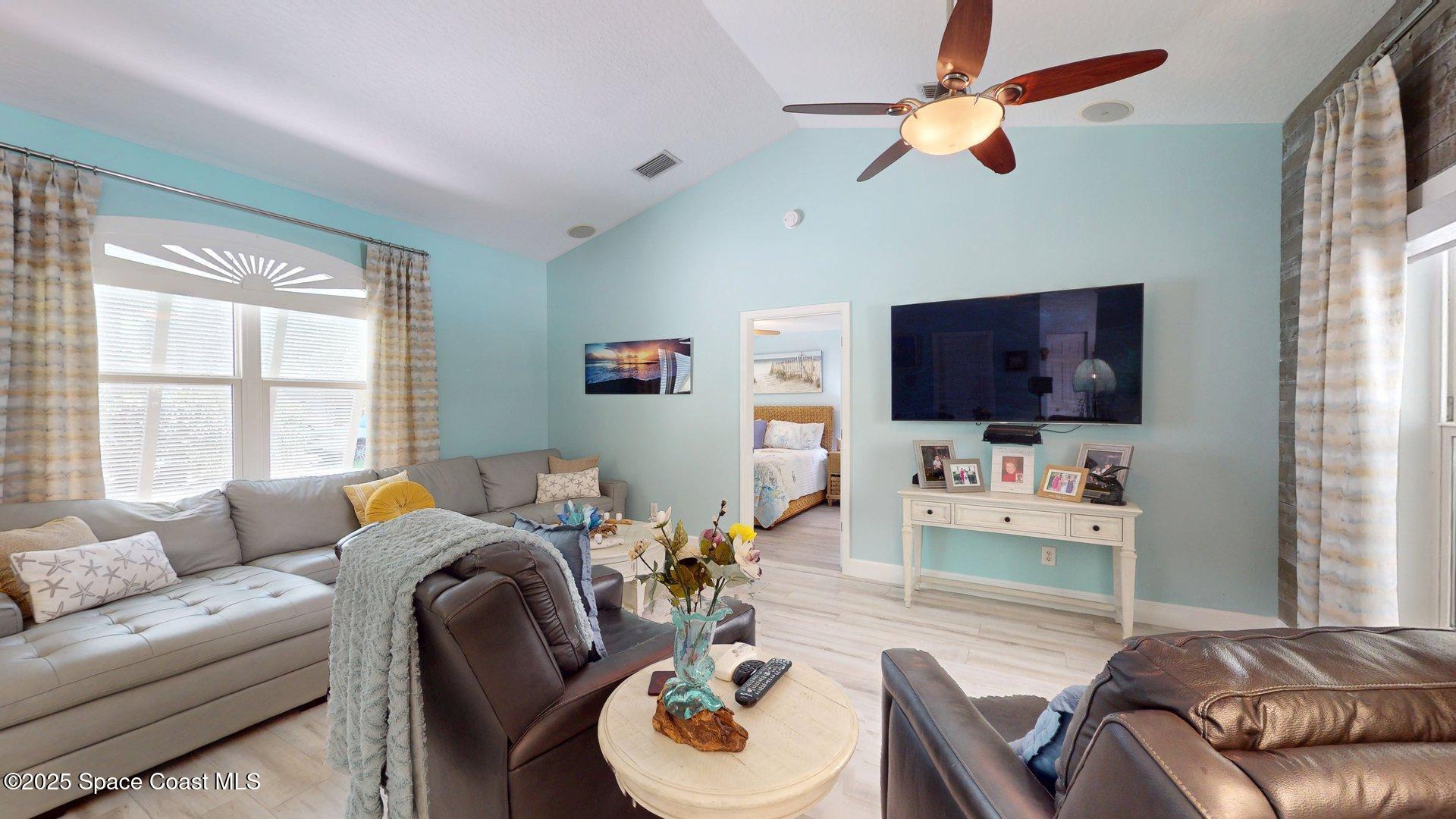 103 Matanzas Road Melbourne Beach, FL 32951 - Photo 26 of 37 a living room with furniture and a flat screen tv