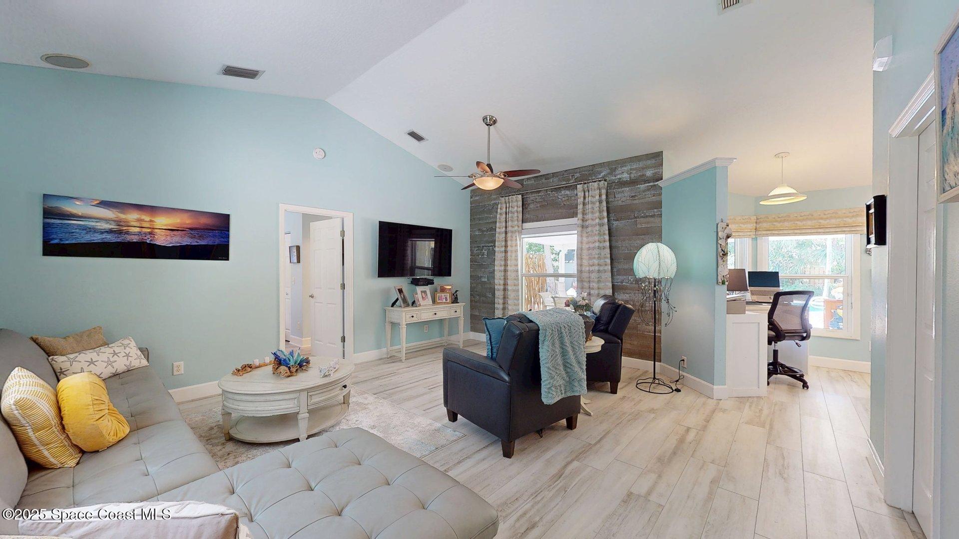 103 Matanzas Road Melbourne Beach, FL 32951 - Photo 29 of 37 a living room with furniture and a flat screen tv