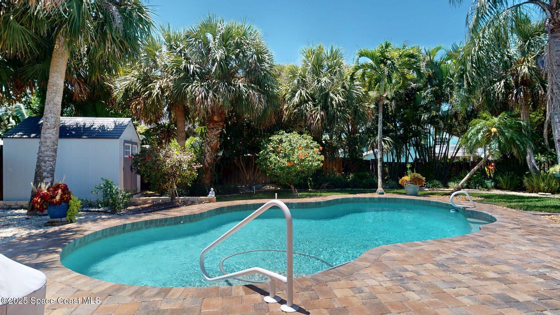 103 Matanzas Road Melbourne Beach, FL 32951 - Photo 3 of 37 a view of a swimming pool with a bench and trees