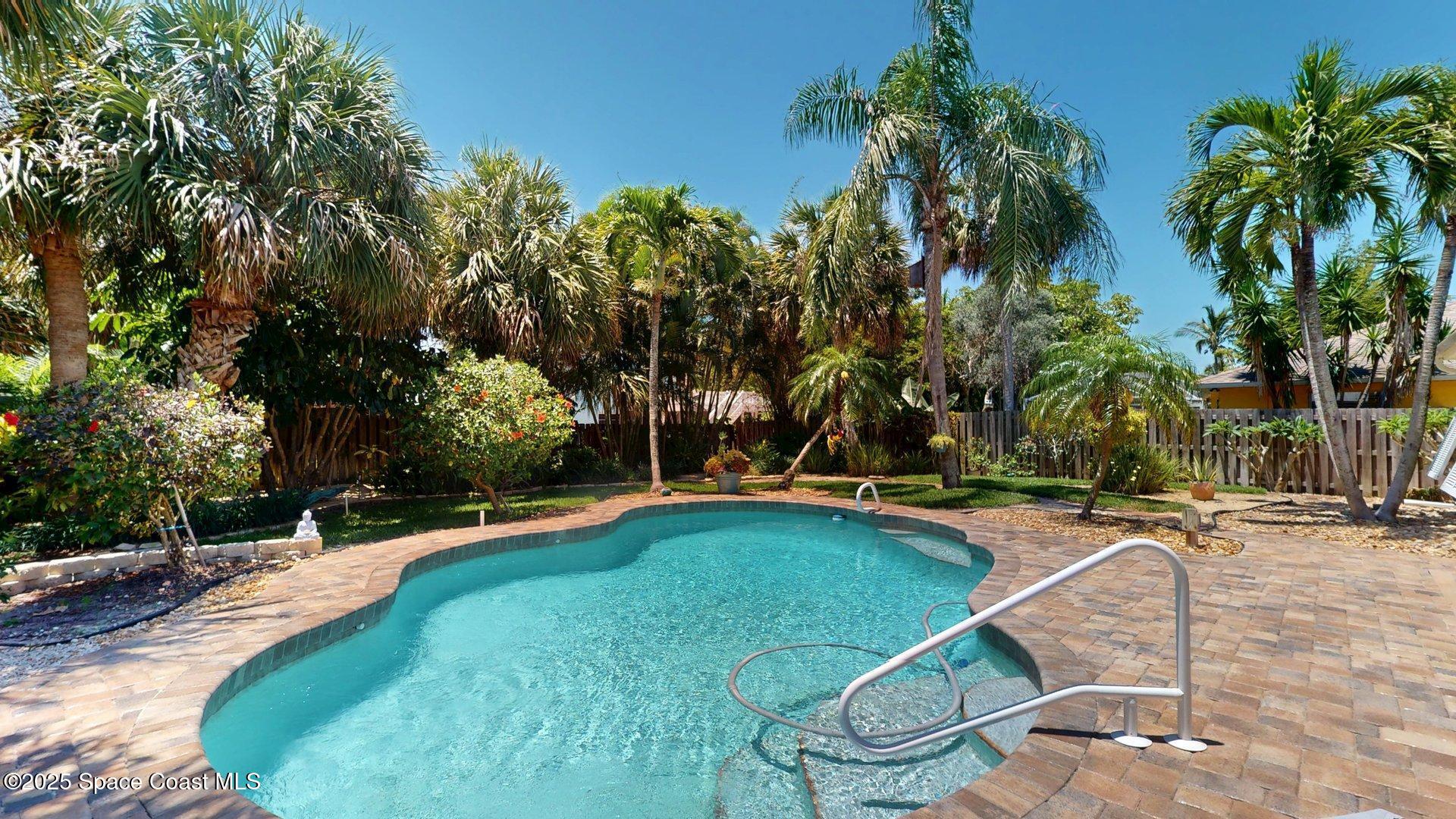 103 Matanzas Road Melbourne Beach, FL 32951 - Photo 7 of 37 a view of a swimming pool with a patio and a yard