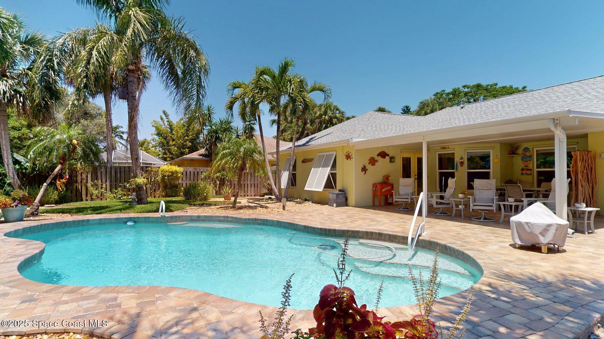 103 Matanzas Road Melbourne Beach, FL 32951 - Photo 8 of 37 a view of a house with backyard patio and swimming pool