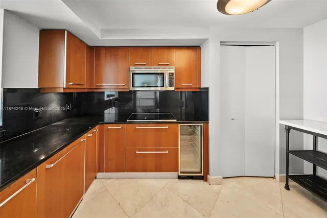 a kitchen with stainless steel appliances granite countertop a refrigerator and a stove