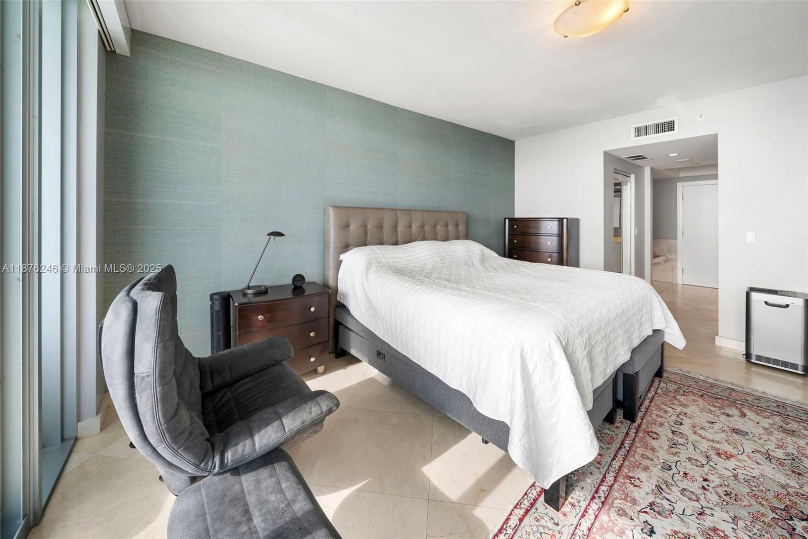 1331 Brickell Bay Drive, Unit 1105 Miami, FL 33131 - Photo 7 of 17 a bedroom with a bed and wooden floor