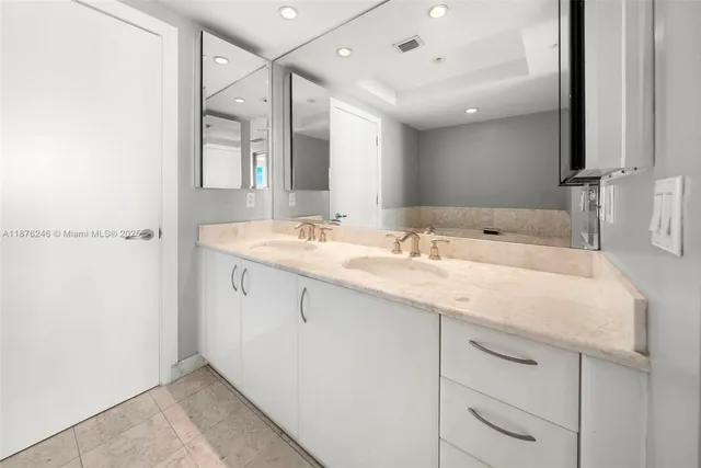 a bathroom with a sink double vanity and a mirror