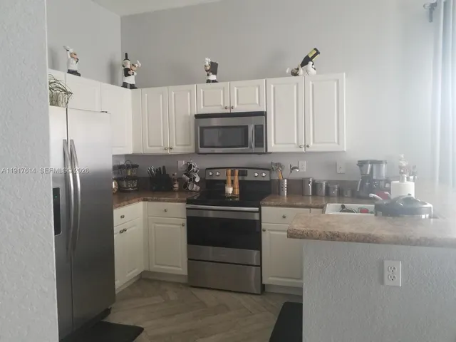 a utility room with sink dryer and washer