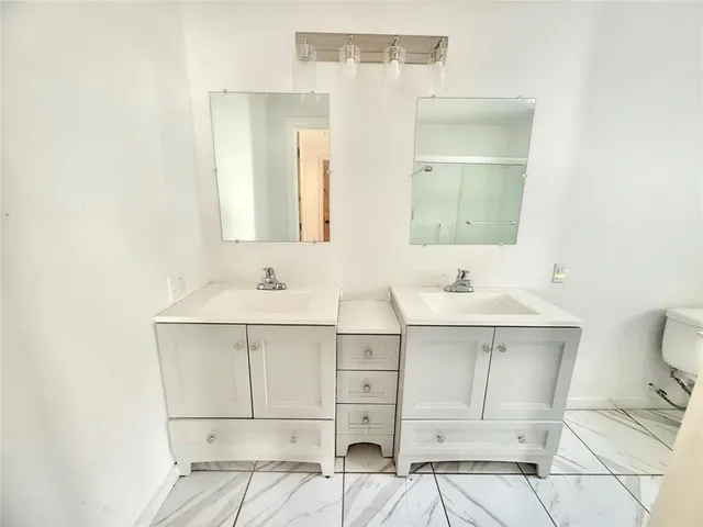 a bathroom with a sink vanity and mirror