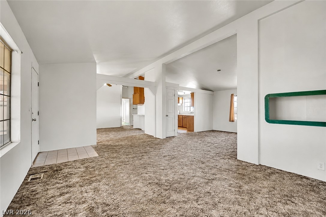 4361 Maple Road Pahrump, NV 89048 - Photo 12 of 35 A spacious living area with wall-to-wall carpeting and neutral walls awaits your personal touch.