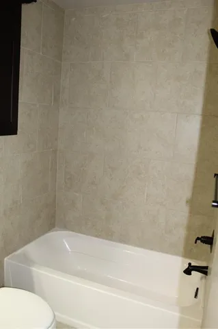 a bathroom with a bathtub and a toilet