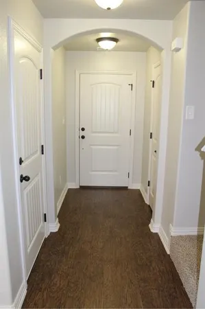 wooden floor with white door
