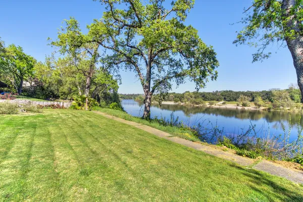 a view of a lake with houses in the back
