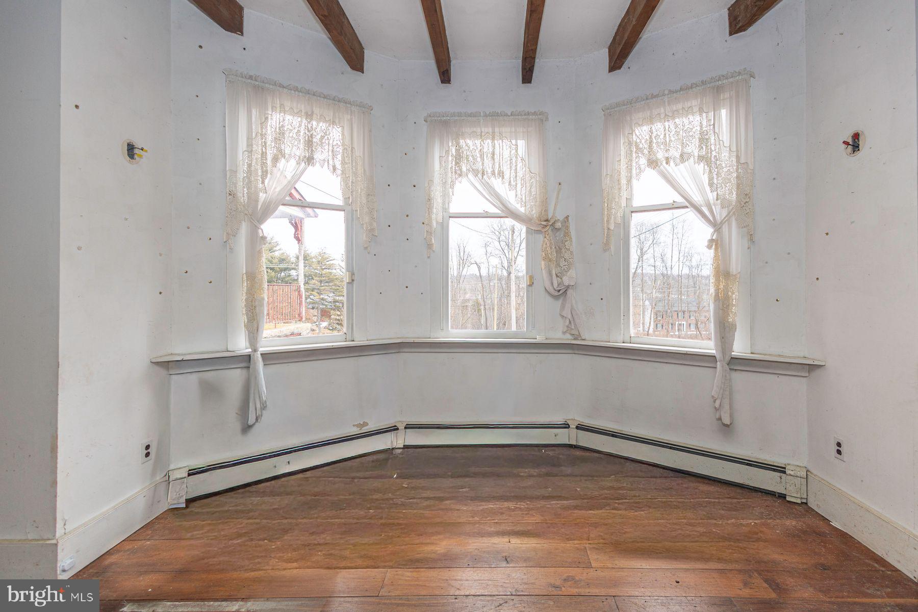 Lot 1 Curly Hill Road Doylestown, PA 18902 - Photo 28 of 40 a view of an empty room with wooden floor and a window