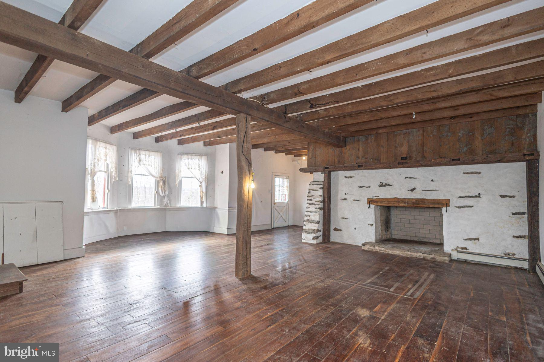 Lot 1 Curly Hill Road Doylestown, PA 18902 - Photo 30 of 40 a view of an empty room with exposed radiator and fireplace