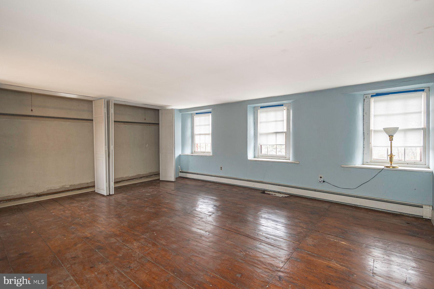 Lot 1 Curly Hill Road Doylestown, PA 18902 - Photo 33 of 40 an empty room with wooden floor and windows