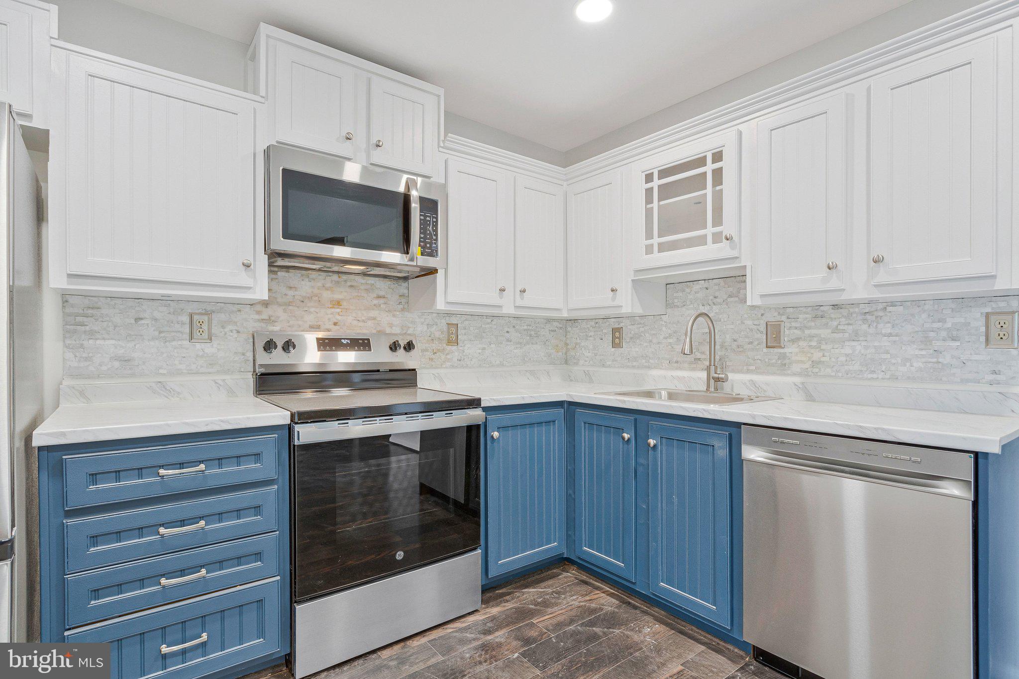 1675 Ridgely Court, Unit 182 Crofton, MD 21114 - Photo 27 of 47 a kitchen with stainless steel appliances granite countertop a stove and a microwave