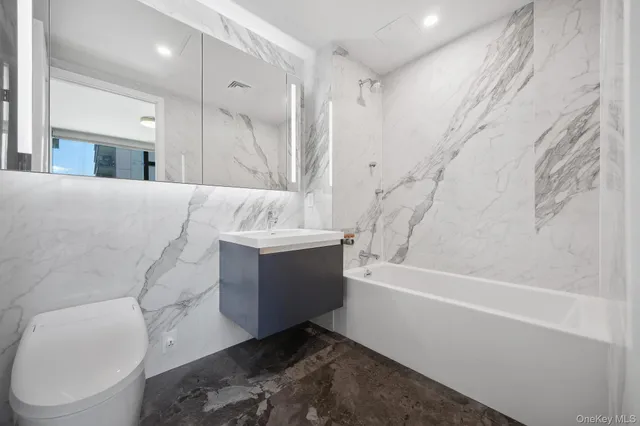 a bathroom with a bathtub sink and toilet