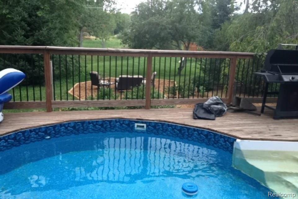 2659 Byron Road Howell, MI 48855 - Photo 36 of 45 Inviting pool with gorgeous views overlooking gardens and firepit area