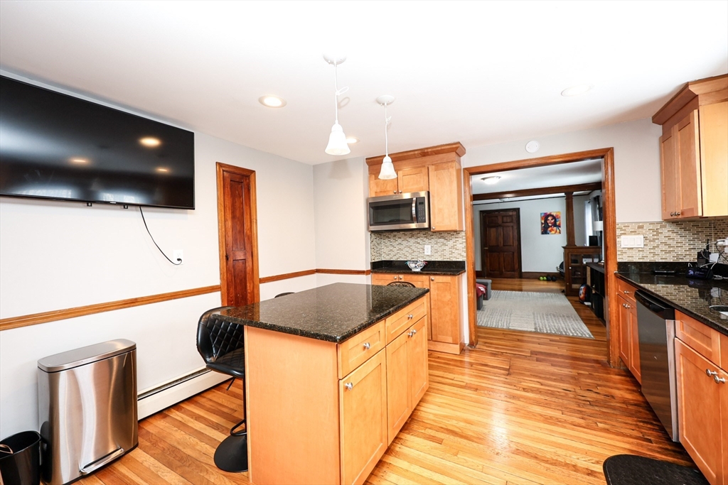 a kitchen with stainless steel appliances granite countertop a sink and a stove top oven