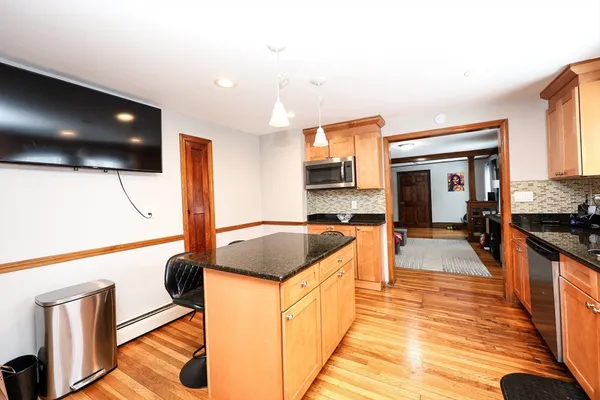 a kitchen with stainless steel appliances kitchen island granite countertop a sink and cabinets