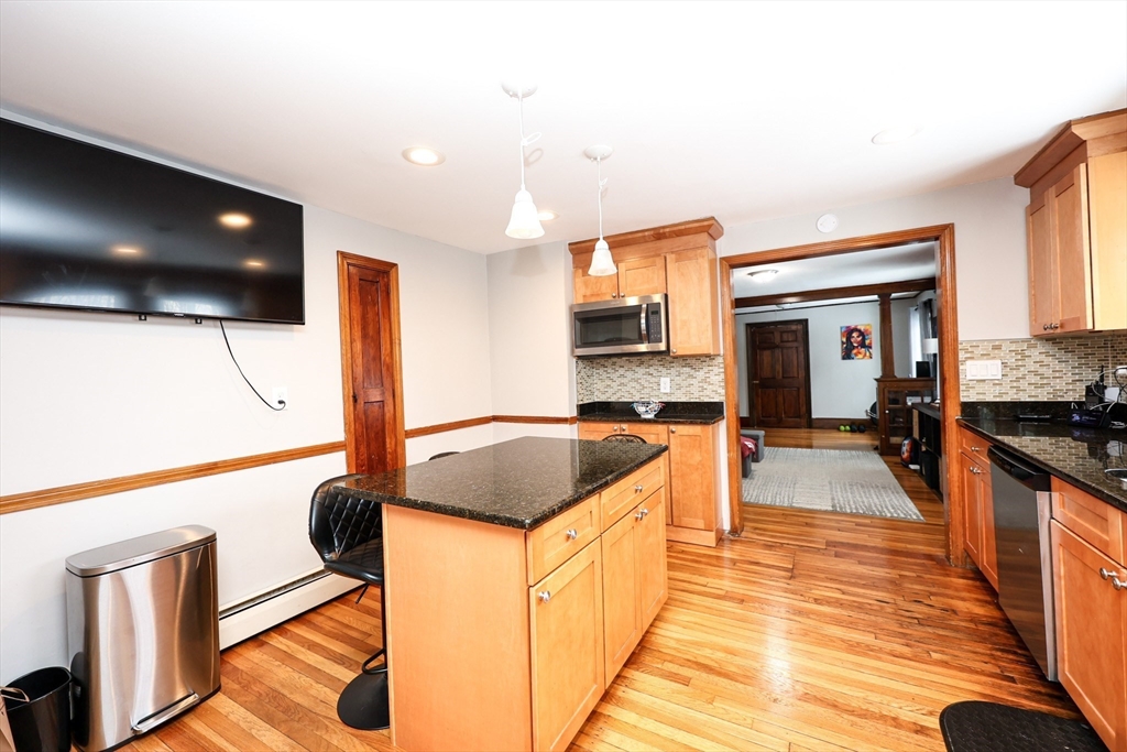 65 Clifford Street, Unit 2 Boston, MA 02136 - Photo 16 of 27 a kitchen with stainless steel appliances kitchen island granite countertop a sink and cabinets