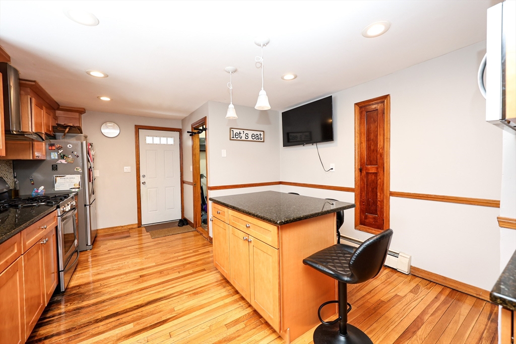 65 Clifford Street, Unit 2 Boston, MA 02136 - Photo 20 of 27 a kitchen with stainless steel appliances granite countertop a stove and a refrigerator