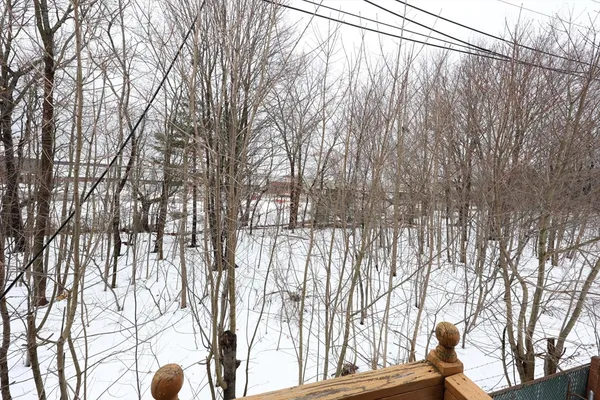 a backyard of a house with lots of green space and outdoor seating