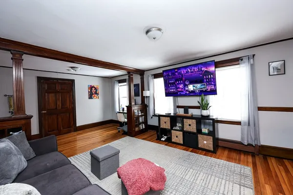 a living room with furniture and wooden floor