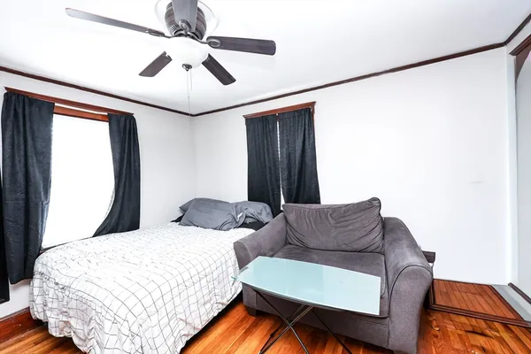 a bedroom with a bed couch and window