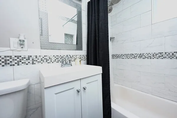 a bathroom with a sink a toilet and mirror