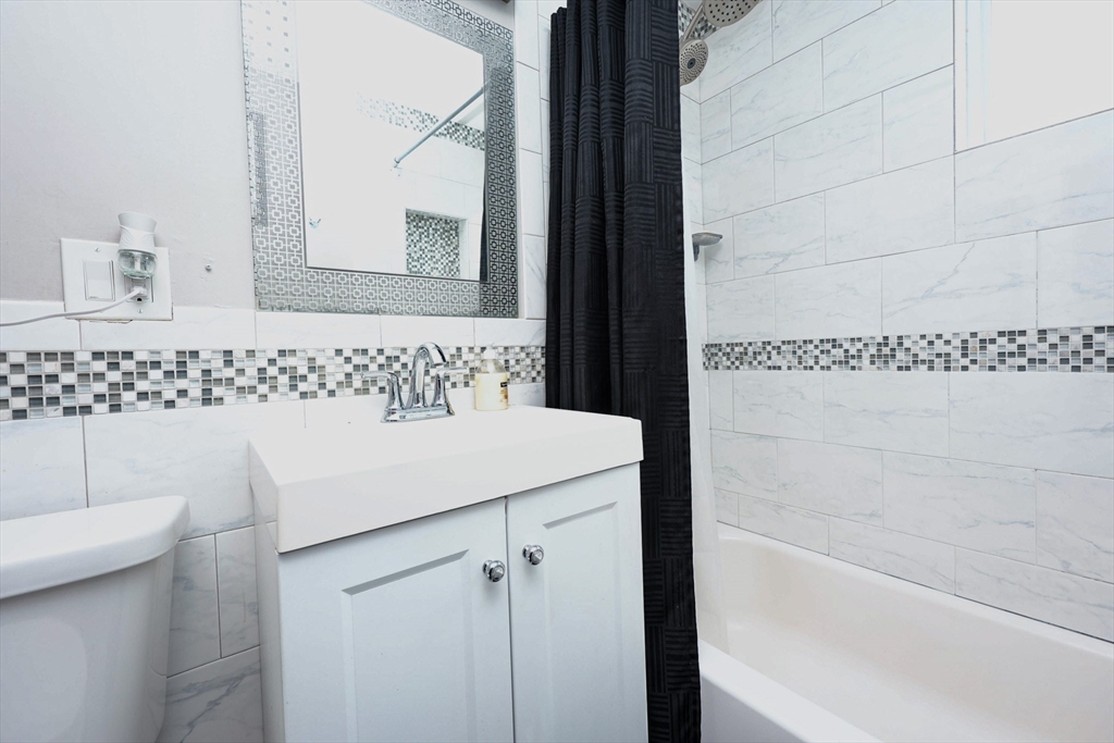 65 Clifford Street, Unit 2 Boston, MA 02136 - Photo 9 of 27 a bathroom with a sink a toilet and mirror