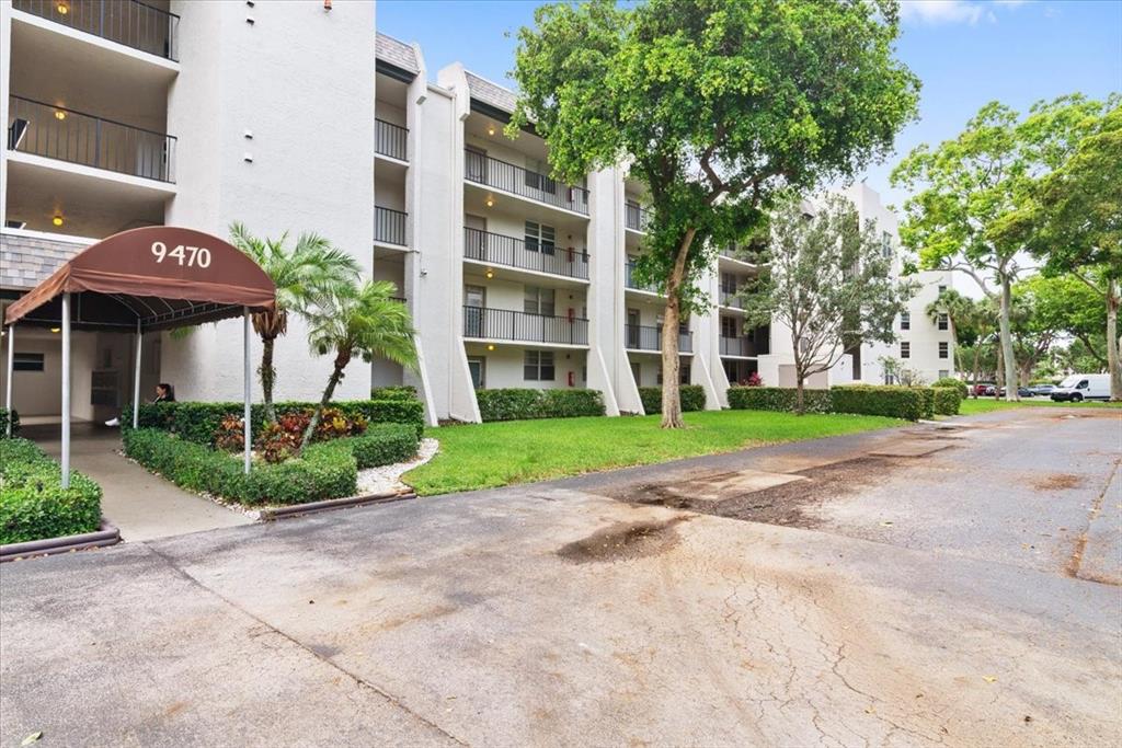 9470 Poinciana Place, Unit 1#103 Davie, FL 33324 - Photo 22 of 32 a view of a building with a yard