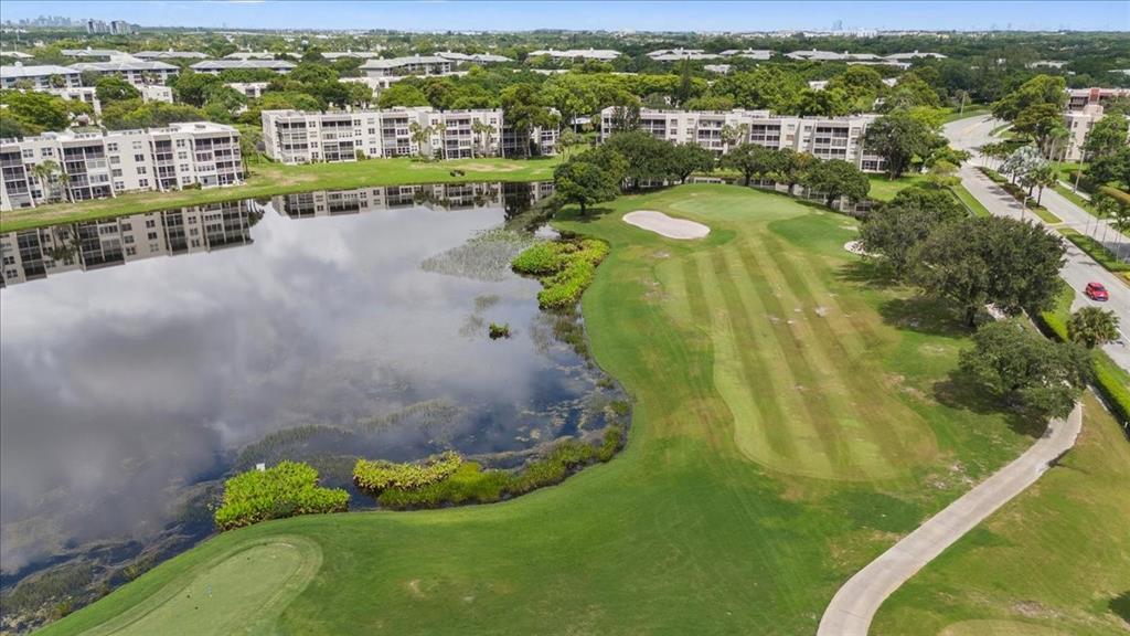 9470 Poinciana Place, Unit 1#103 Davie, FL 33324 - Photo 23 of 32 a view of a lake with a city