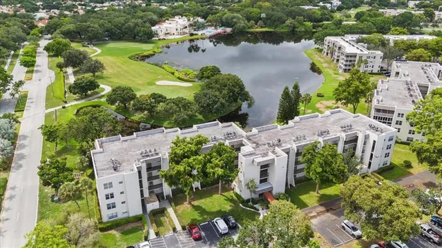 an aerial view of a house with a garden and lake view