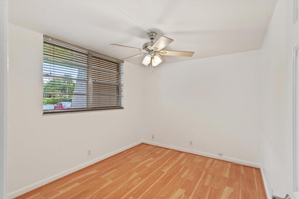 9470 Poinciana Place, Unit 1#103 Davie, FL 33324 - Photo 6 of 32 wooden floor in an empty room with a window