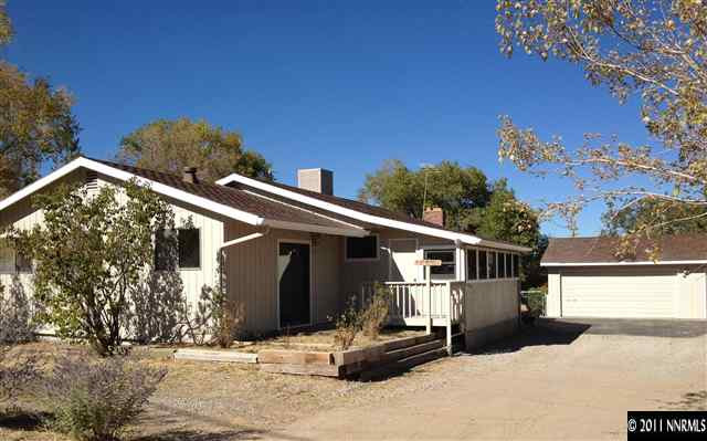 1305 Hot Springs Road Reno, NV 89521 - Photo 1 of 13 a front view of a house with a yard