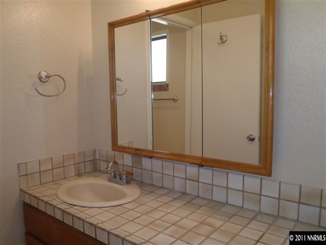 1305 Hot Springs Road Reno, NV 89521 - Photo 11 of 13 a bathroom with a sink a vanity and a mirror
