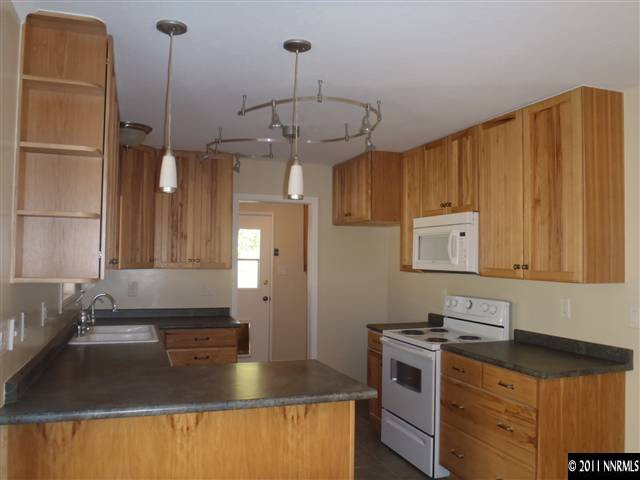 1305 Hot Springs Road Reno, NV 89521 - Photo 3 of 13 a kitchen with stainless steel appliances granite countertop a sink a stove and a refrigerator