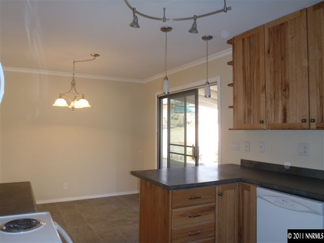 1305 Hot Springs Road Reno, NV 89521 - Photo 5 of 13 a kitchen that has a lot of cabinets and wooden floor