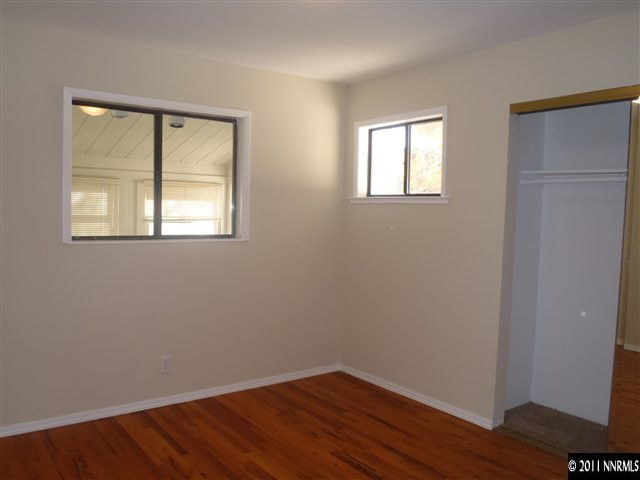 1305 Hot Springs Road Reno, NV 89521 - Photo 7 of 13 a view of an empty room with wooden floor and a window