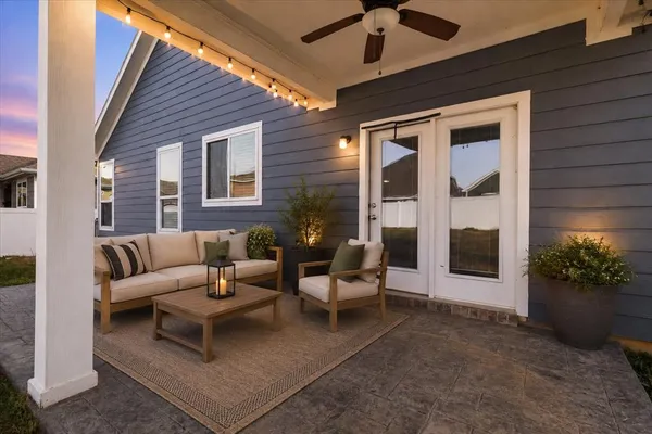 a outdoor living space with furniture potted plant and a large window