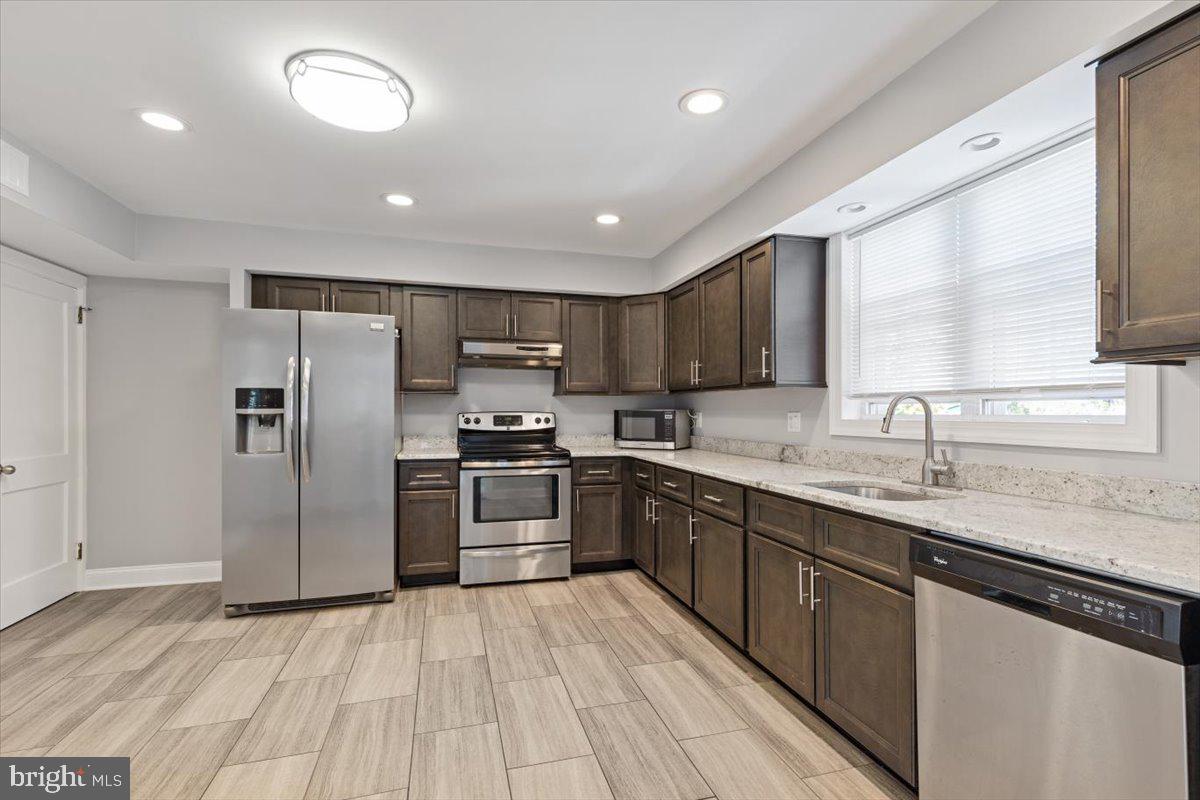 2921 Cowpath Road Hatfield, PA 19440 - Photo 8 of 30 a kitchen with stainless steel appliances granite countertop a sink refrigerator and cabinets