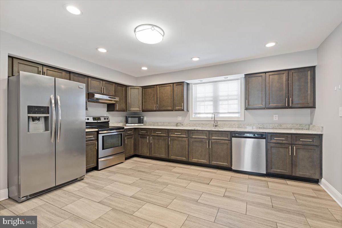 2921 Cowpath Road Hatfield, PA 19440 - Photo 9 of 30 a large kitchen with granite countertop a large counter top stainless steel appliances and cabinets