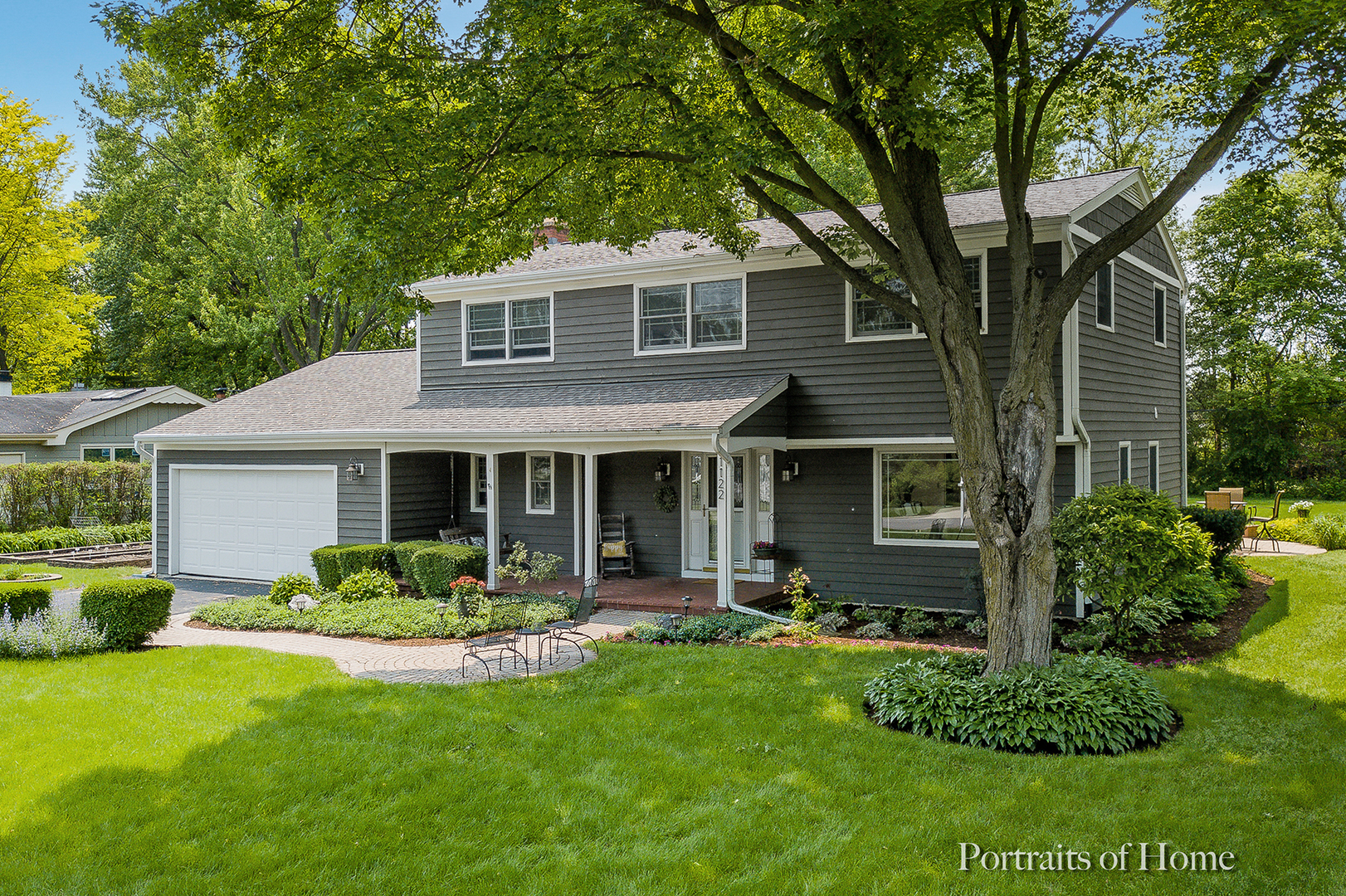 a front view of house with yard and outdoor seating