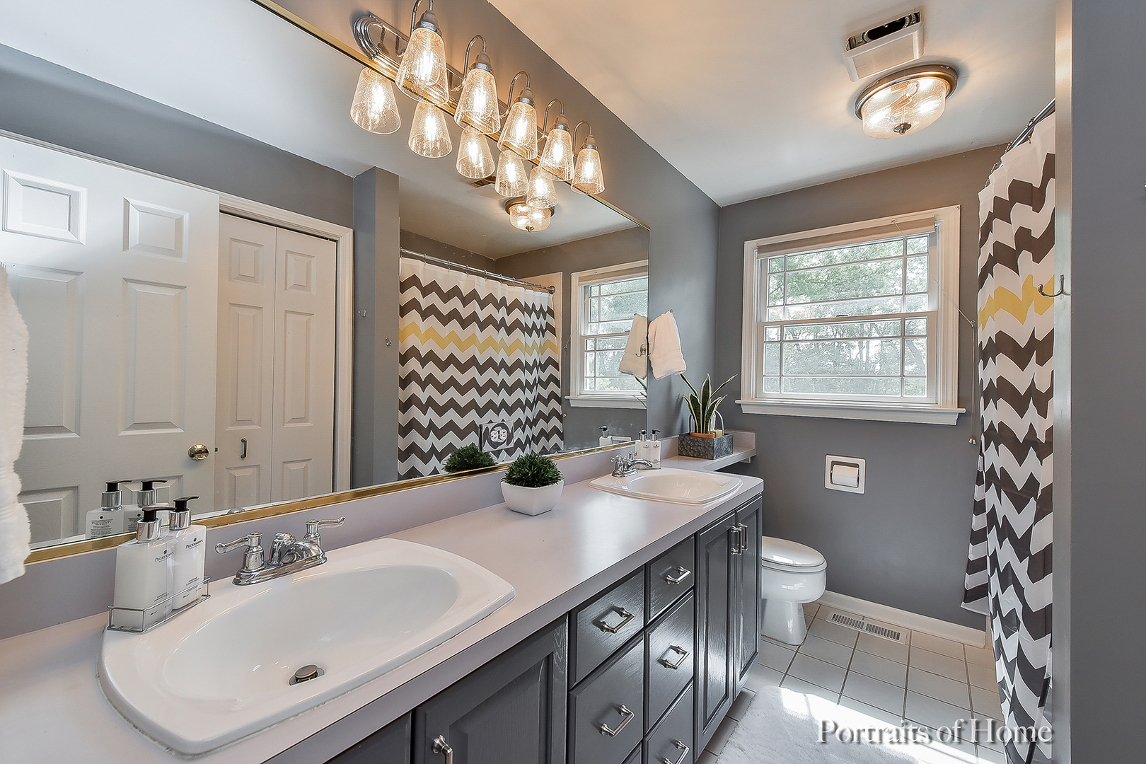 1122 Dunstan Road Geneva, IL 60134 - Photo 22 of 37 a bathroom with a sink a toilet and a mirror
