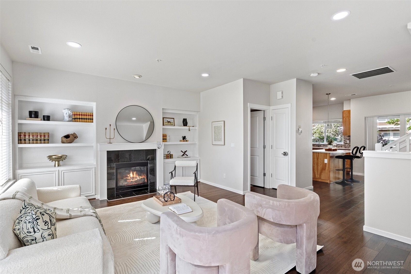 83 Sky Ridge Road Northwest Issaquah, WA 98027 - Photo 1 of 28 a living room with furniture a fireplace and a dining table with wooden floor