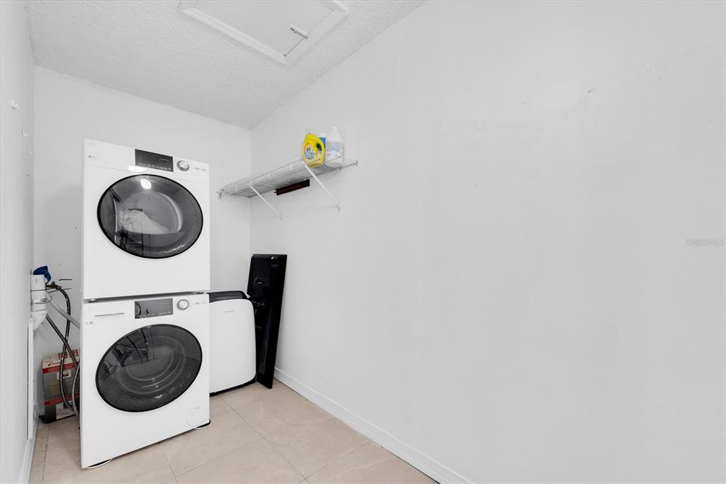 171 Medallion Boulevard, Unit F Madeira Beach, FL 33708 - Photo 19 of 30 a utility room with dryer and washer
