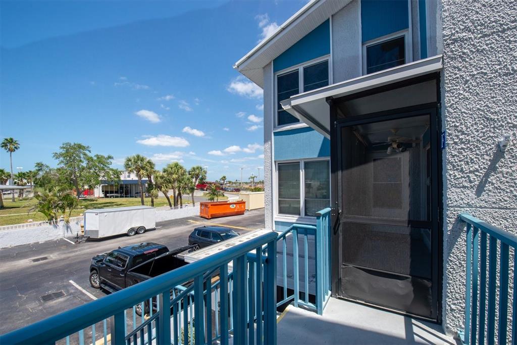 171 Medallion Boulevard, Unit F Madeira Beach, FL 33708 - Photo 21 of 30 a city view from the balcony